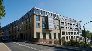 a building on the side of a street at Castle Apartments - Queen in Oświęcim