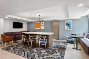 a lobby with a table and chairs and a couch at Holiday Inn Express Atlanta Airport - North, an IHG Hotel in Atlanta