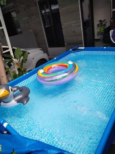 a frisbee and a toy in a swimming pool at Family Villa Syariah C-33 with minipool in Batu