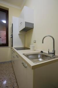 a kitchen with a sink and a counter top at Al Castello Avezzano in Avezzano