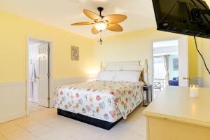 a bedroom with a bed and a ceiling fan at Pawleys Island Retreat - Golf Cart Included! in Pawleys Island