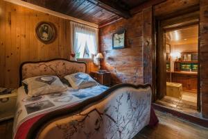 - une chambre avec un lit dans une cabane en bois dans l'établissement Chalet La Voraz, à Châtel