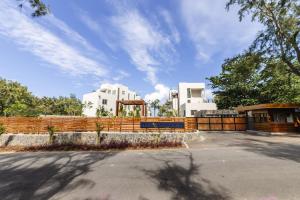 a building with a fence in front of it at Ocean Terraces Apt A1 - Your Beachfront Bliss - Brand NEW in Poste Lafayette