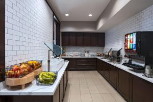 a kitchen with a counter with baskets of fruit on it at Residence Inn Beaumont in Beaumont