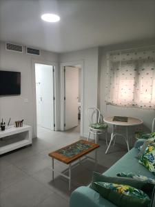 a living room with a couch and a table at Marea apartamento. in Adra