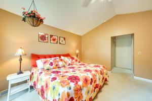 a bedroom with a bed with a colorful bedspread at Pet-Friendly Pennsylvania Abode - Deck and Fireplace in Gibsonia