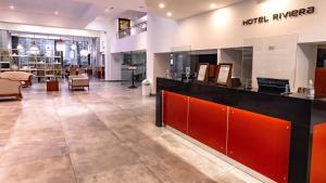 a lobby of a store with a counter and chairs at Hotel Riviera in Mar del Plata