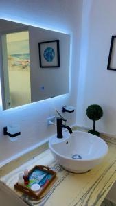 a bathroom with a sink and a mirror on a counter at La Isla Bonita in Punta Rucia