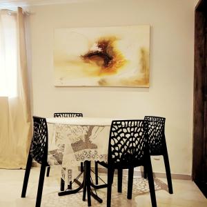 カボ・フリオにあるCasa aconchegante! perto de Búzios e Cabo Frioのテーブルと椅子2脚、壁画