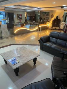 a living room with a couch and a coffee table at Hotel Palace in Cachoeiras de Macacu