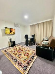 a living room with a couch and a rug at Spacious One bedroom apartment Edgeware Road Central London in London