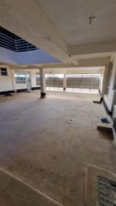 an empty building with a large empty parking lot at Exquisite 1br Apartment along Eldoret-Kisumu Road close to Eldoret Polytechnic in Eldoret