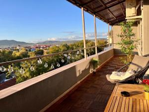 a balcony with a table and a view of a city at Ghinda Nest in Bistriţa +14 photos
