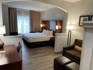 a large hotel room with a bed and a couch at Comfort Suites Salisbury I-85 in Salisbury