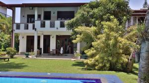 a house with a pool in front of it at Villa Riverplace in Beruwala