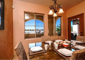 a dining room with a table and chairs and a window at Condo 31-1, Right in front of the Pool with WiFi in Playa El Paraíso