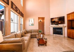 a living room with a couch and a fireplace at Condo 31-1, Right in front of the Pool with WiFi in Playa El Paraíso