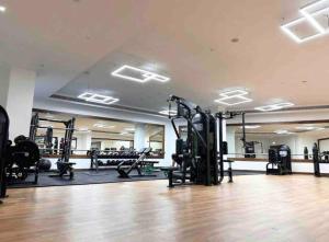 a gym with treadmills and machines in a room at Panoramic Luxury Apartment in Abu Dhabi