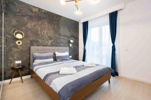 a bedroom with a large bed and a large window at Blue Velvet in Bucharest