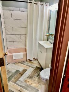 a bathroom with a toilet and a sink at The Crossroads Motel in Elkhorn