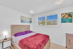 a bedroom with a large bed and two windows at Hollywood Vacation Mins To Beach & Hard Rock #193 in Hollywood
