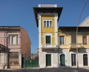 a yellow and white building on a city street at Villa Giulia BnB in Viareggio