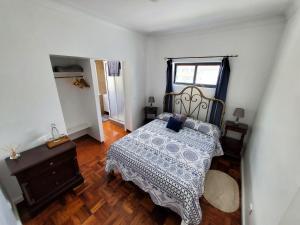 a bedroom with a bed and a wooden floor at Pousada da Vila in Vila Franca do Campo