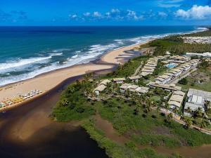 an aerial view of a beach with a resort at Residence Cotê d' Azur in Imbassai
