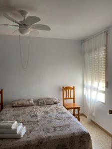 a bedroom with a bed and a ceiling fan at La Carihuela in Torremolinos