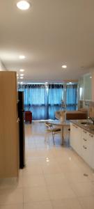 a large kitchen with a table and a dining room at Airport BleuSuite Apartment in Catia La Mar