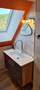 a bathroom with a sink and a window at Czas relaksu in Jedlina-Zdrój