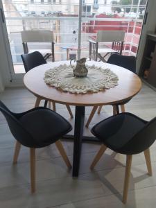 a table with two chairs and a tea pot on it at Palmas de Recoleta in Buenos Aires