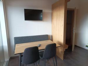 a room with a table and two chairs and a television at Haus Lagger in Seefeld in Tirol