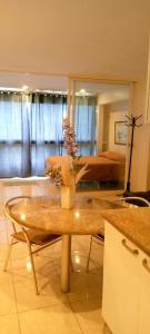a living room with a table with flowers on it at Airport BleuSuite Apartment in Catia La Mar