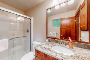 a bathroom with a sink and a shower and a toilet at Bigfork Beauty in Bigfork +17 photos