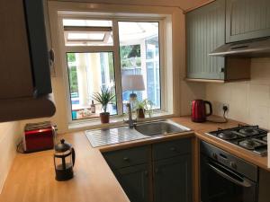 a kitchen with a sink and a window at Whitstable Link in Whitstable
