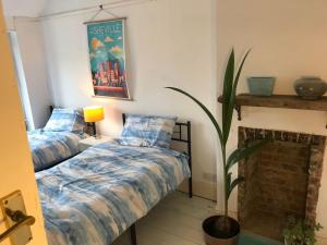 a bedroom with two beds and a fireplace at Whitstable Link in Whitstable