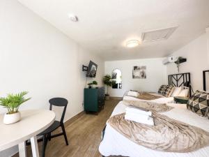a room with three beds and a table at 2 Q Studio Apt With Shared Pool 510 in Clearwater