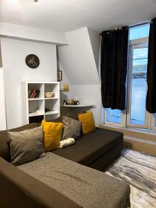 a living room with a couch and a window at 1 Bed apartment with a balcony in London