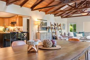 a kitchen and living room with a wooden table at Starry Nights - River Wineries Huge Fenced Yard in Forestville