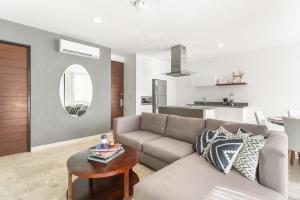 a living room with a couch and a table at Downtown Condos Luxury in Playa del Carmen