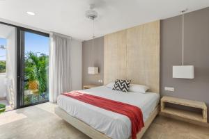 a bedroom with a large bed and a large window at Downtown Condos Luxury in Playa del Carmen +23 photos