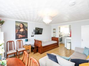 a living room with a couch and a table at 63 The Waterside Holiday Park in Lowestoft