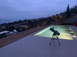 a camera on a tripod on top of a roof at Stylish Villa - Skylodge in Tolo