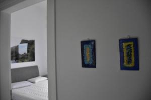 a room with two pictures on the wall and a couch at Stylish Villa - Skylodge in Tolo +19 photos