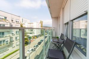 a balcony with a table and a view of a city at Flexible SelfCheckIns 56 - Zagreb - Garage - Loggia - New in Zagreb