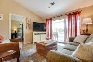 a living room with a couch and a tv at Centrally Located Branson Condo Step-Free Access in Branson