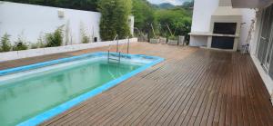 a swimming pool on the deck of a house at Raco - Alma Zen in Tipas