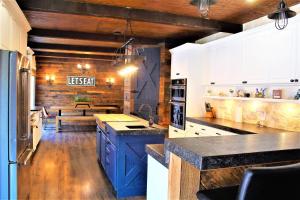 a kitchen with blue cabinets and a bench in the background at The Rustic Inn - Family friendly, Close to Fiesta Texas, SeaWorld, Riverwalk and more in Dominion