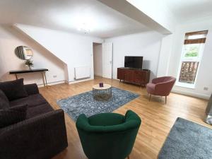 a living room with a couch and a table at 4Bed House MK in Simpson